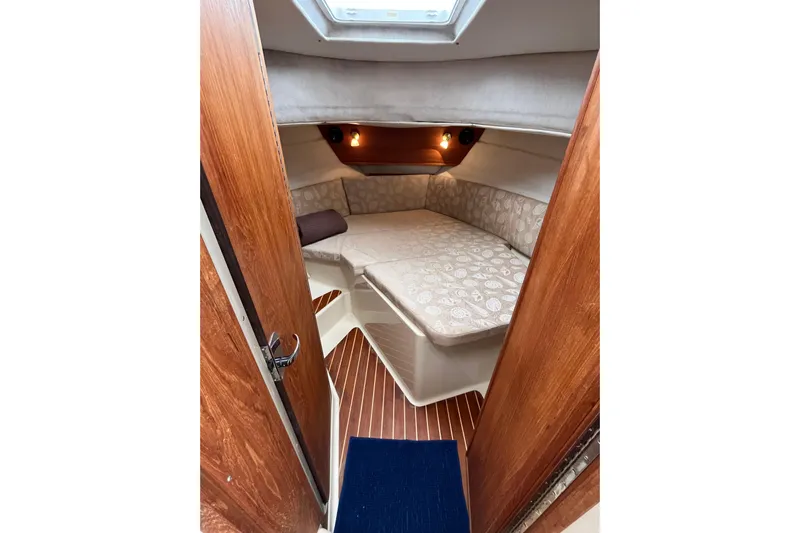 Rockin' Robin Yacht Photos Pics 2009 Ranger Tugs R-29 cabin interior with cozy bed and wooden accents.