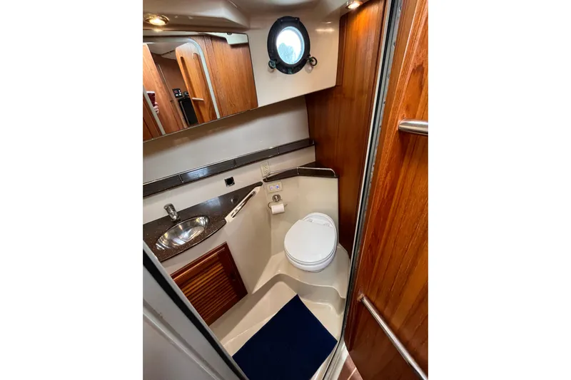 Rockin' Robin Yacht Photos Pics 2009 Ranger Tugs R-29 boat bathroom with wood accents and porthole window.
