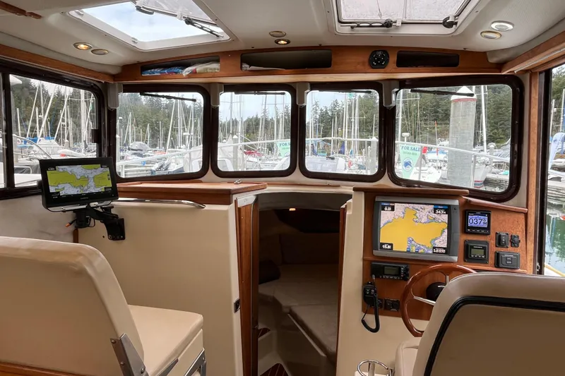 Rockin' Robin Yacht Photos Pics Interior of 2009 Ranger Tugs R-29 boat with navigation equipment and marina view.