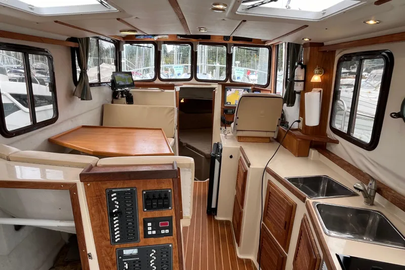 Rockin' Robin Yacht Photos Pics Interior of 2009 Ranger Tugs R-29 boat with wood accents and modern amenities.