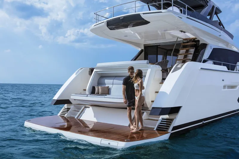  Yacht Photos Pics 2025 Ferretti Yachts 720 on open sea with two people on deck.