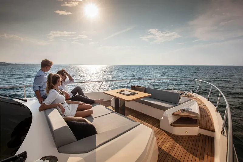  Yacht Photos Pics People relaxing on a 2025 Ferretti Yachts 720, enjoying a sunny ocean view.