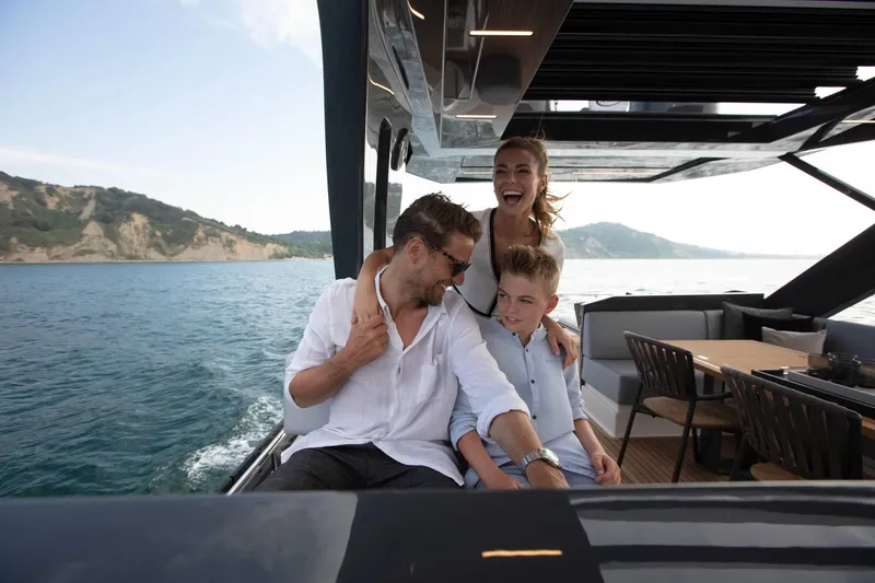  Yacht Photos Pics Family enjoying a day on a 2025 Ferretti Yachts 720, cruising along scenic coastline.