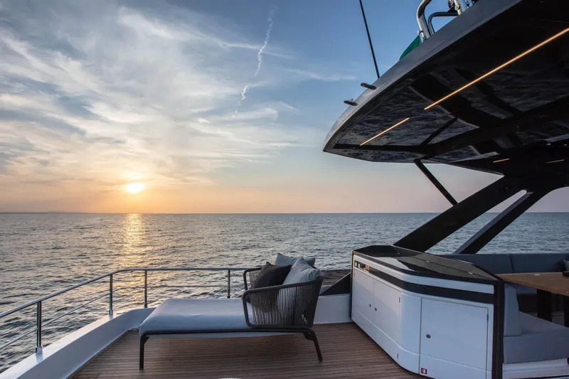  Yacht Photos Pics Luxurious 2025 Ferretti Yachts 720 at sunset, featuring elegant deck and ocean view.