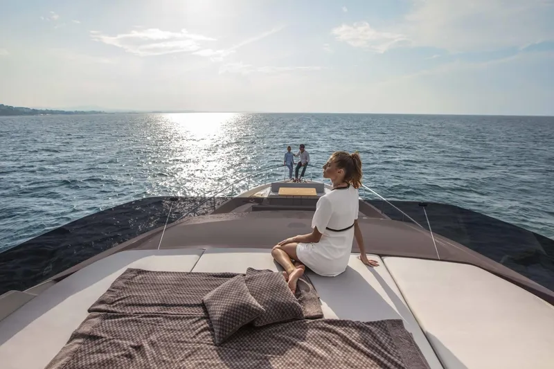  Yacht Photos Pics Luxury Ferretti Yachts 720 cruising on open sea, 2025 model, with people relaxing onboard.