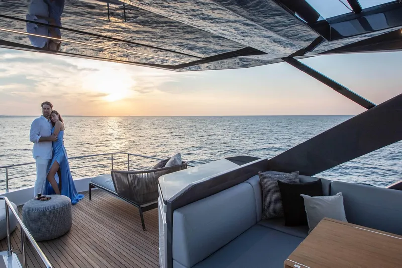  Yacht Photos Pics Couple enjoying sunset on luxurious 2025 Ferretti Yachts 720 deck.