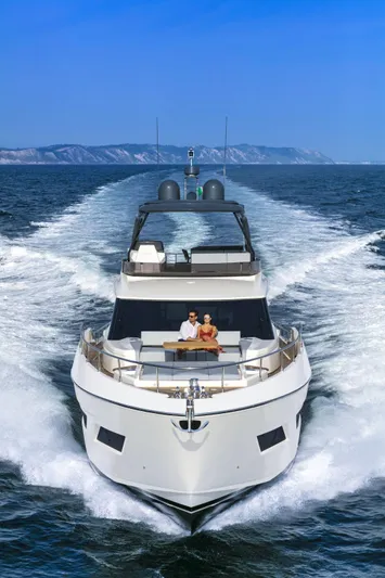  Yacht Photos Pics 2025 Ferretti Yachts 720 cruising on open sea with passengers enjoying the view.