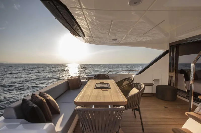  Yacht Photos Pics Luxurious Ferretti Yachts 720 deck with elegant seating, ocean view, and sunset ambiance, 2025 model.