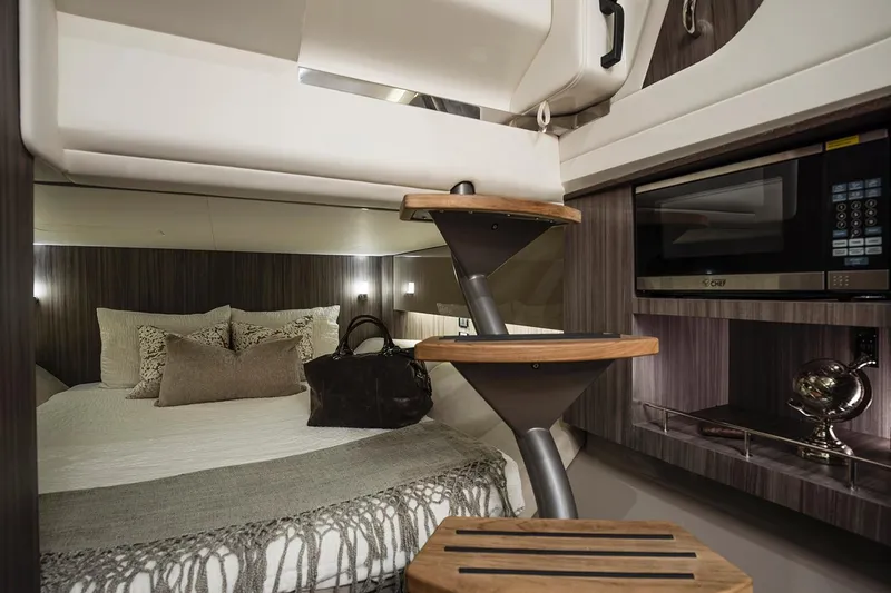  Yacht Photos Pics Manufacturer Provided Image: Luxurious interior of 2025 Sea Ray SLX 400 yacht with cozy bed and modern amenities.