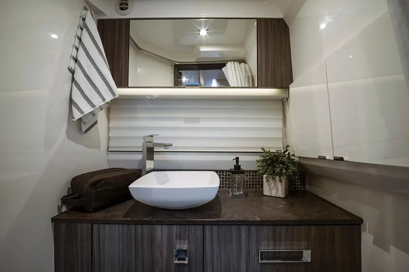  Yacht Photos Pics Manufacturer Provided Image: Luxurious bathroom interior of 2025 Sea Ray SLX 400 yacht with modern sink and decor.