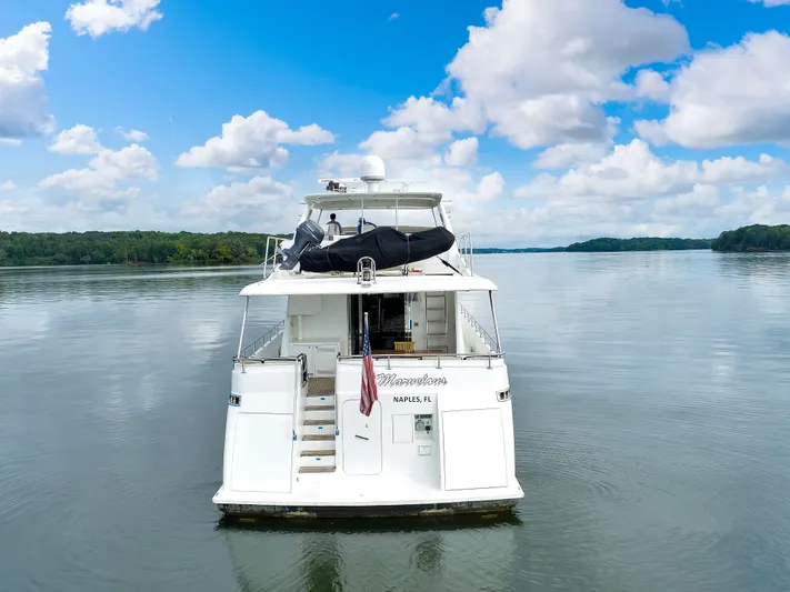 Marvelous Yacht Photos Pics 1999 Cheoy Lee 74 yacht on calm water under a partly cloudy sky.