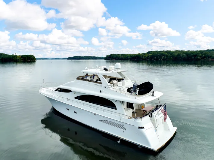 Marvelous Yacht Photos Pics 1999 Cheoy Lee 74 yacht on calm water under a partly cloudy sky.