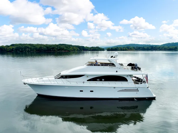 Marvelous Yacht Photos Pics 1999 Cheoy Lee 74 yacht on calm water under a blue sky with clouds.