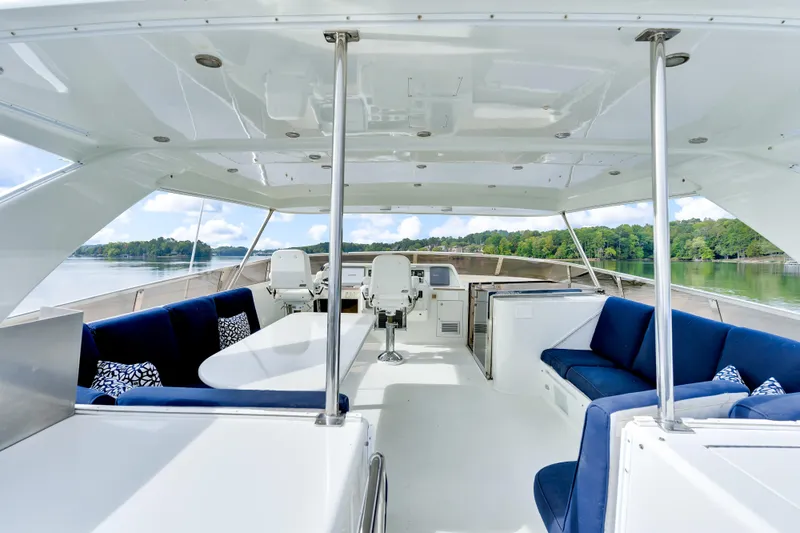 Marvelous Yacht Photos Pics Luxurious 1999 Cheoy Lee 74 yacht interior with blue seating and scenic water view.