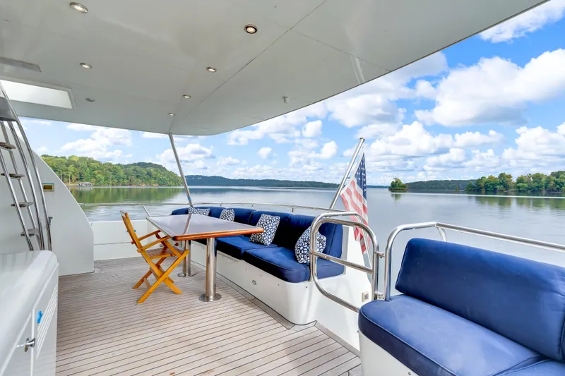 Marvelous Yacht Photos Pics Luxury Cheoy Lee 74 yacht deck with seating, table, and scenic lake view, 1999 model.