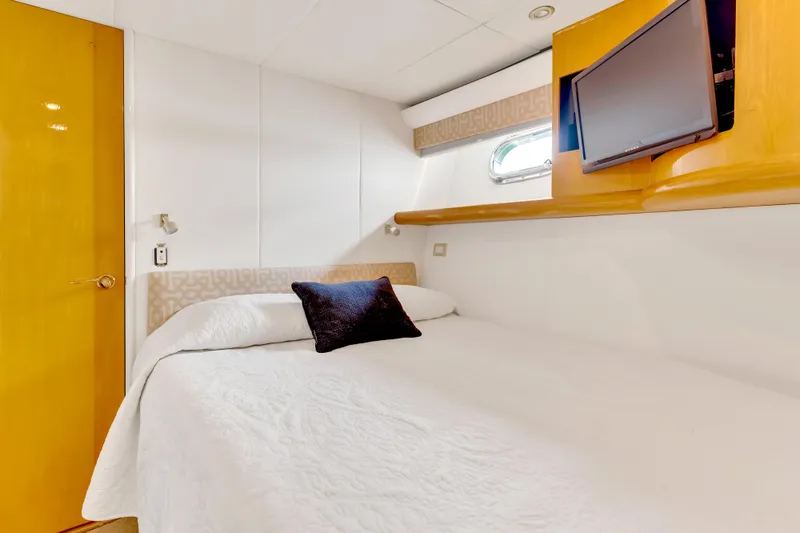 Marvelous Yacht Photos Pics Luxurious cabin interior of 1999 Cheoy Lee 74 yacht with bed and TV.