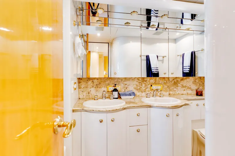 Marvelous Yacht Photos Pics Luxurious bathroom in a 1999 Cheoy Lee 74 yacht, featuring dual sinks and elegant decor.