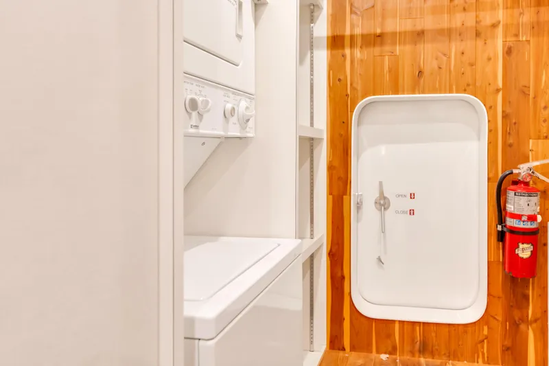 Marvelous Yacht Photos Pics Laundry area on 1999 Cheoy Lee 74 yacht with washer, dryer, and safety door.