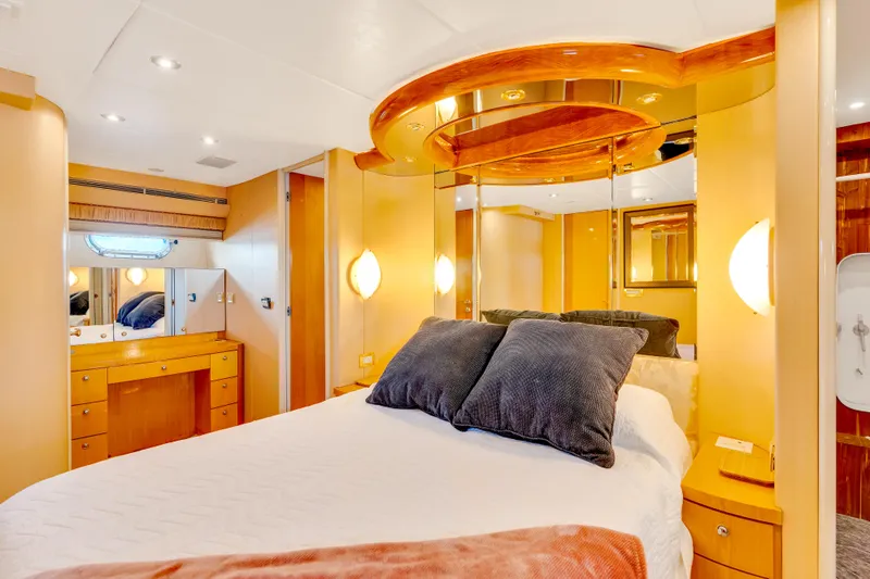 Marvelous Yacht Photos Pics Luxurious bedroom interior of 1999 Cheoy Lee 74 yacht with elegant wood finishes.