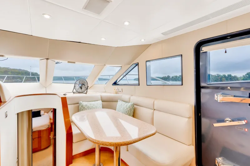 Marvelous Yacht Photos Pics Luxurious interior of 1999 Cheoy Lee 74 yacht with elegant seating and panoramic windows.