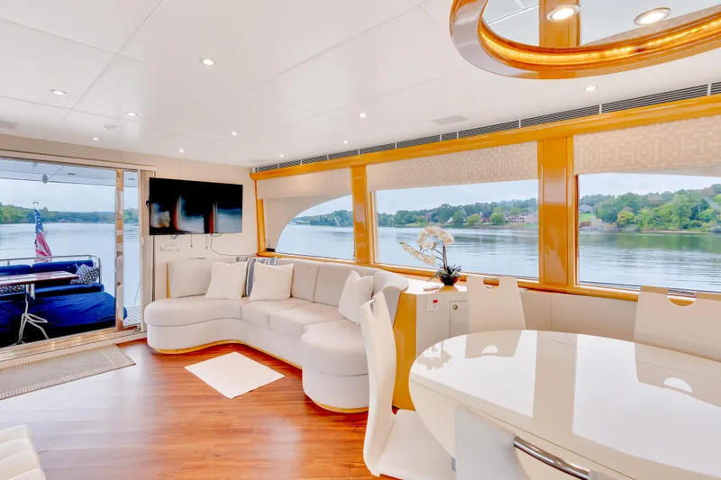 Marvelous Yacht Photos Pics Luxurious interior of 1999 Cheoy Lee 74 yacht with elegant seating and scenic water views.