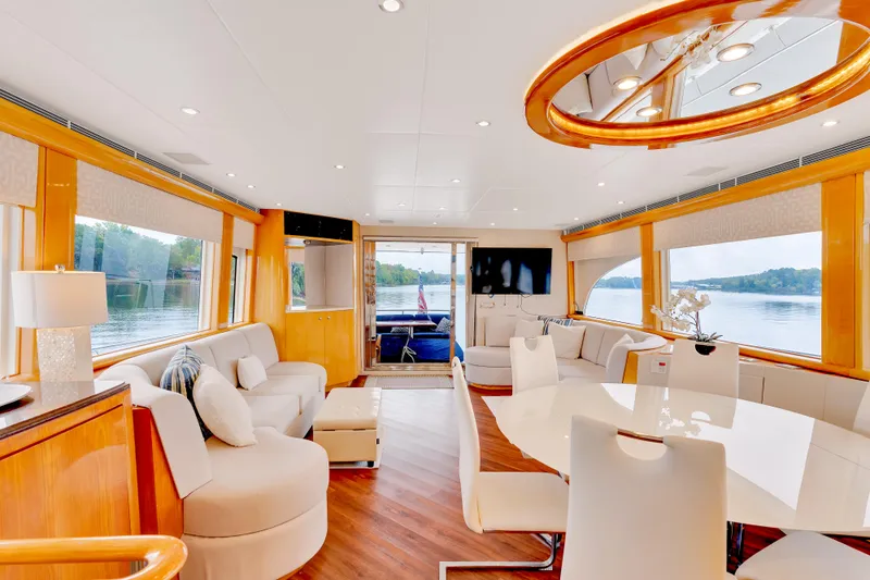 Marvelous Yacht Photos Pics Luxurious interior of 1999 Cheoy Lee 74 yacht with elegant seating and large windows.