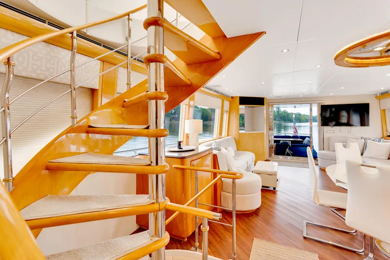 Marvelous Yacht Photos Pics Luxurious interior of 1999 Cheoy Lee 74 yacht with elegant spiral staircase and modern furnishings.