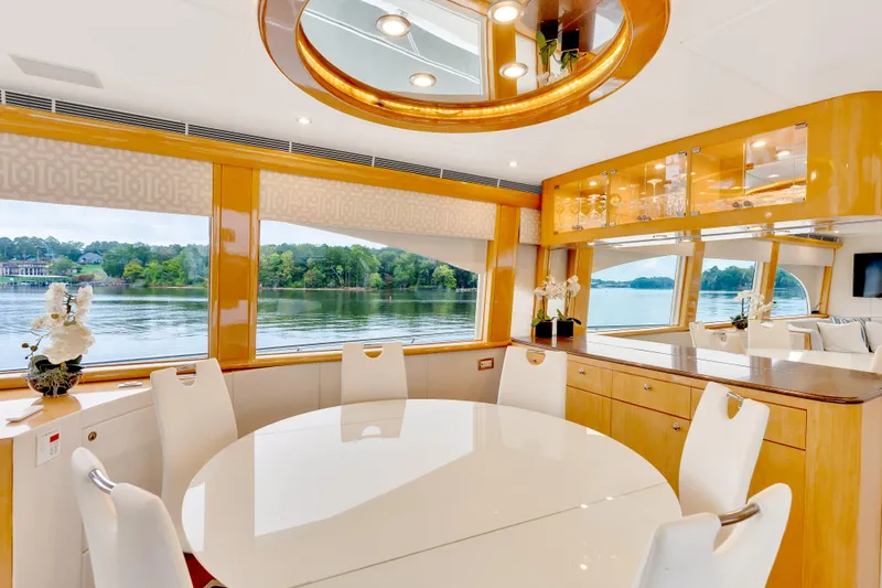 Marvelous Yacht Photos Pics Luxurious interior of 1999 Cheoy Lee 74 yacht with elegant dining area and scenic views.