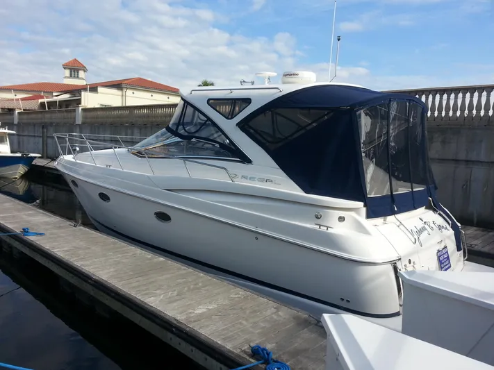 Johnny B Good Yacht Photos Pics 2007 Regal Commodore 4060 yacht docked at marina, featuring sleek design and blue canopy.