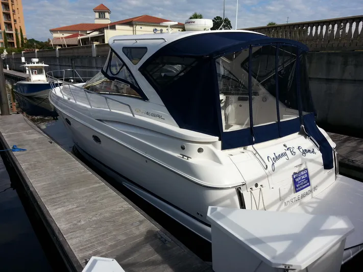 Johnny B Good Yacht Photos Pics 2007 Regal Commodore 4060 yacht docked at marina with blue canopy.