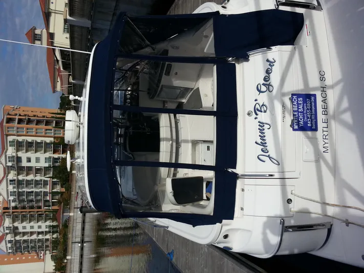 Johnny B Good Yacht Photos Pics 2007 Regal Commodore 4060 yacht docked, featuring blue canopy and "Johnny B. Good" name.