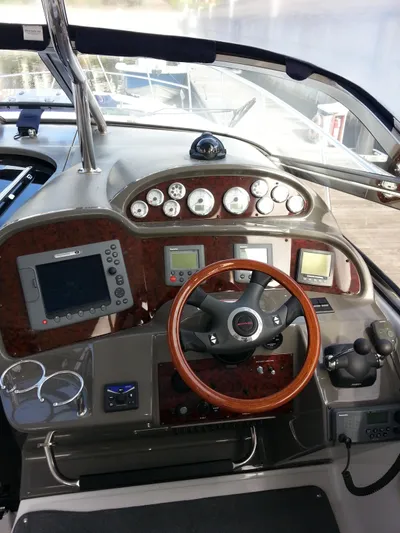 Johnny B Good Yacht Photos Pics 2007 Regal Commodore 4060 helm with wood accents and modern navigation instruments.
