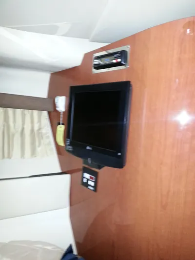 Johnny B Good Yacht Photos Pics 2007 Regal Commodore 4060 interior with mounted TV and control panel.