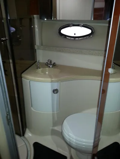 Johnny B Good Yacht Photos Pics 2007 Regal Commodore 4060 yacht bathroom with sink, toilet, and porthole window.