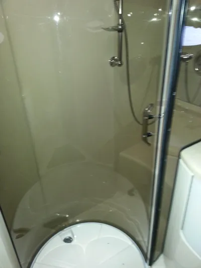 Johnny B Good Yacht Photos Pics Shower area in 2007 Regal Commodore 4060 yacht, featuring glass door and modern fixtures.