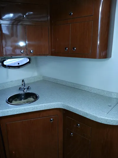 Johnny B Good Yacht Photos Pics 2007 Regal Commodore 4060 yacht kitchen with wooden cabinets and stainless steel sink.