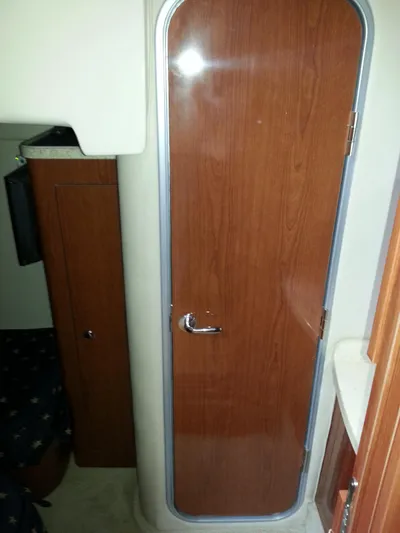 Johnny B Good Yacht Photos Pics 2007 Regal Commodore 4060 cabin interior with wooden door and compact design.