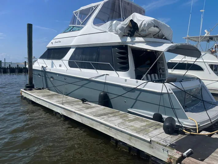  Yacht Photos Pics 1999 Carver 530 Voyager Pilothouse yacht docked at marina under clear blue sky.