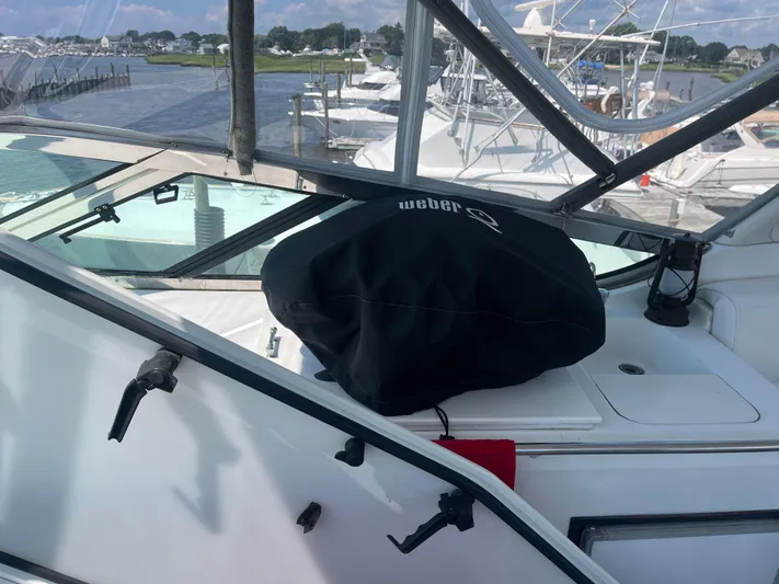  Yacht Photos Pics 1999 Carver 530 Voyager Pilothouse with covered grill on deck, marina view.