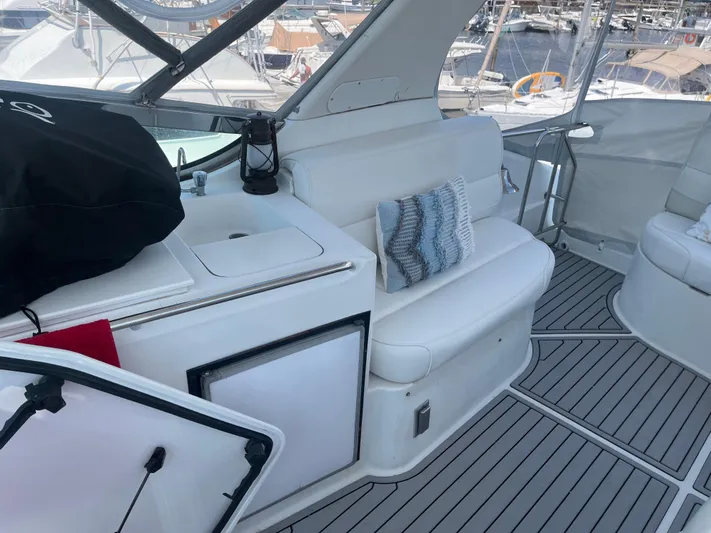  Yacht Photos Pics 1999 Carver 530 Voyager Pilothouse interior with white seating and marina view.