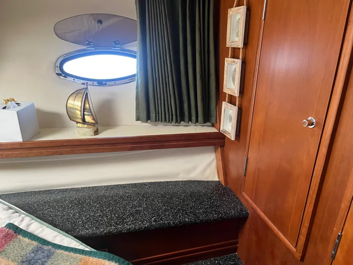 Yacht Photos Pics Interior of 1999 Carver 530 Voyager Pilothouse with porthole, wooden cabinetry, and decorative accents.