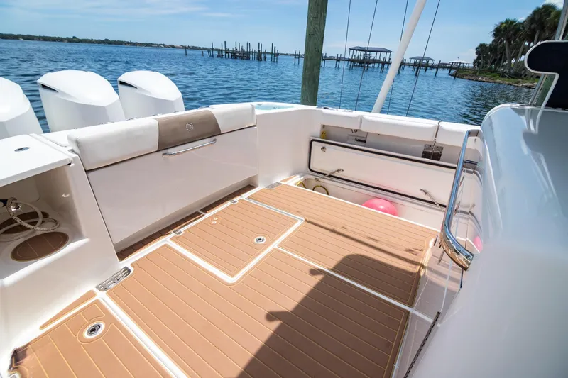  Yacht Photos Pics 2016 Edgewater 368CC boat deck with seating, storage, and scenic waterfront view.
