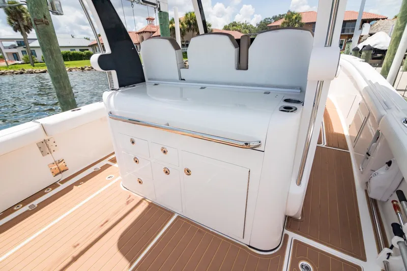  Yacht Photos Pics 2016 Edgewater 368CC boat interior with sleek white cabinetry and wood-textured flooring.