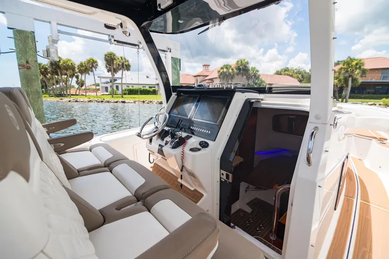  Yacht Photos Pics 2016 Edgewater 368CC boat interior with helm, seating, and waterfront view.