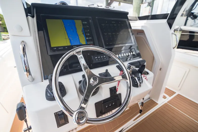  Yacht Photos Pics 2016 Edgewater 368CC boat helm with navigation screens and steering wheel.