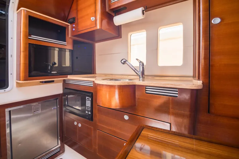  Yacht Photos Pics Luxurious 2016 Edgewater 368CC boat interior with modern kitchen amenities.