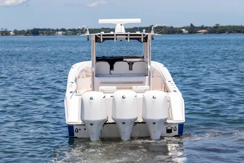  Yacht Photos Pics 2016 Edgewater 368CC boat with triple outboard engines on calm water.