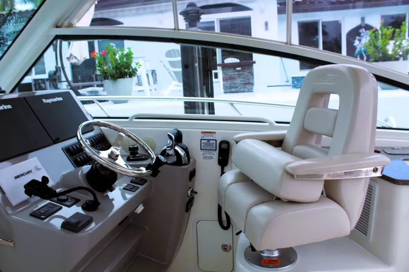 F-troop Yacht Photos Pics Helm of 2017 Boston Whaler 345 Conquest with steering wheel and captain's chair.