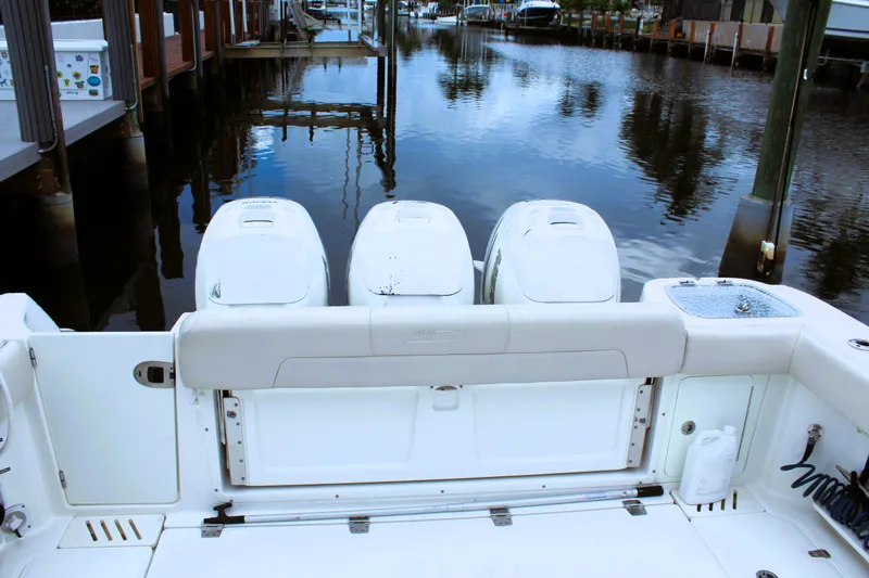 F-troop Yacht Photos Pics 2017 Boston Whaler 345 Conquest boat with triple outboard engines docked by the water.