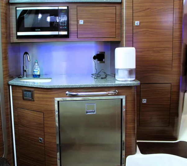 F-troop Yacht Photos Pics 2017 Boston Whaler 345 Conquest galley with microwave, sink, and stainless steel fridge.